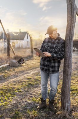 full-shot-man-holding-tablet-outdoors